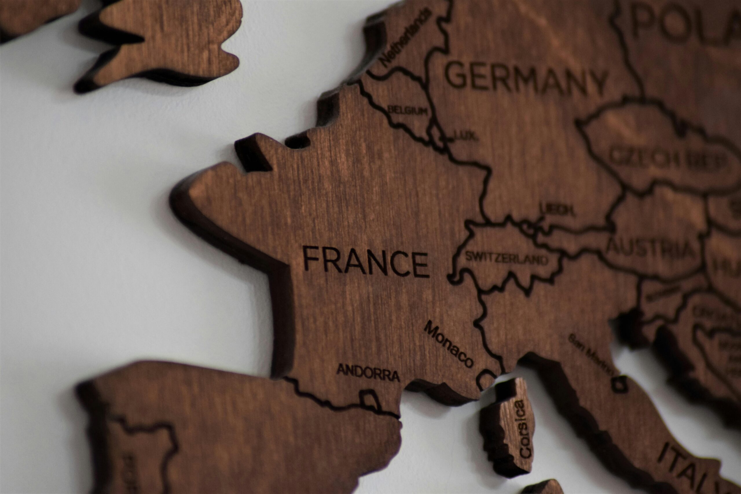 Close-up view of a wooden map highlighting the country of France within Europe.